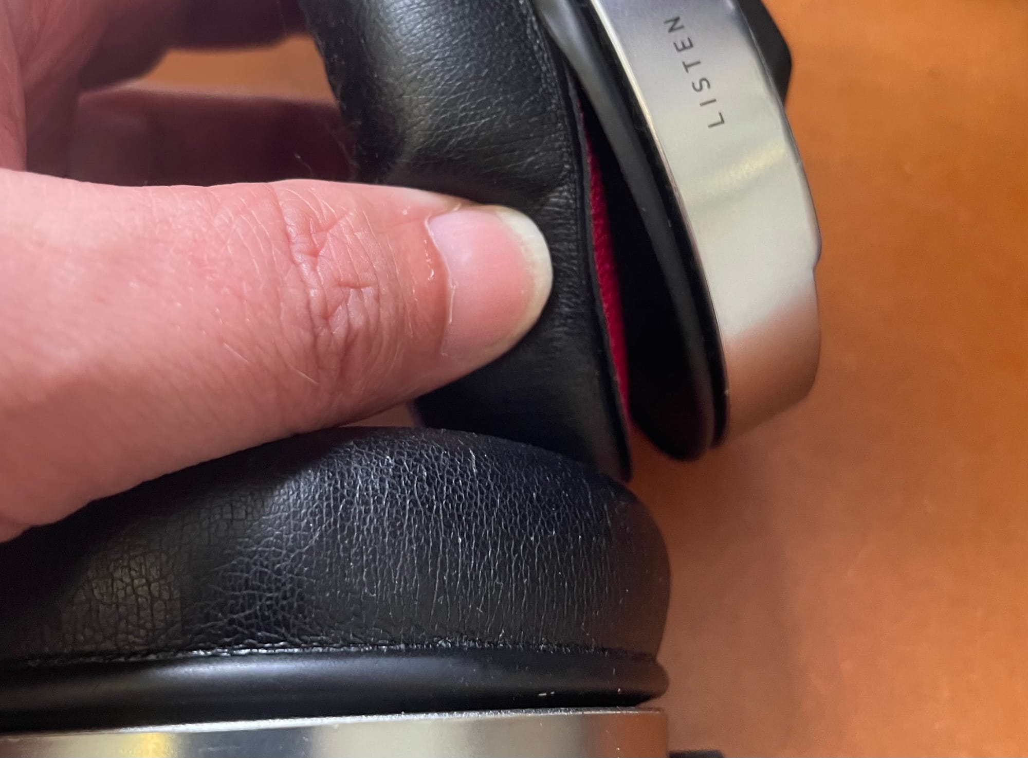 A pair of Focal Listens with a torn pad.